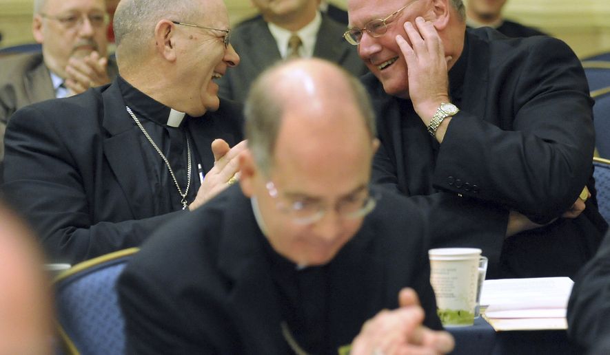 Bishop Kevin Vann, left, of Fort Worth, Texas, congratulates Archbishop Timothy Dolan, right, of New York after Archbishop Dolan was elected president of the U.S. Conference of Catholic Bishops during the conference&#39;s annual fall meeting Tuesday, Nov. 16, 2010, in Baltimore. (AP Photo/Steve Ruark)