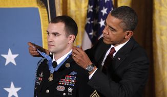 President Obama presents the Medal of Honor to Army Staff Sgt. Salvatore Giunta during a ceremony in the East Room of the White House in Washington, Tuesday, Nov. 16, 2010. Sgt. Giunta, from Hiawatha, Iowa, is the first living veteran of the wars in Iraq and Afghanistan to receive the award. (AP Photo/Charles Dharapak)