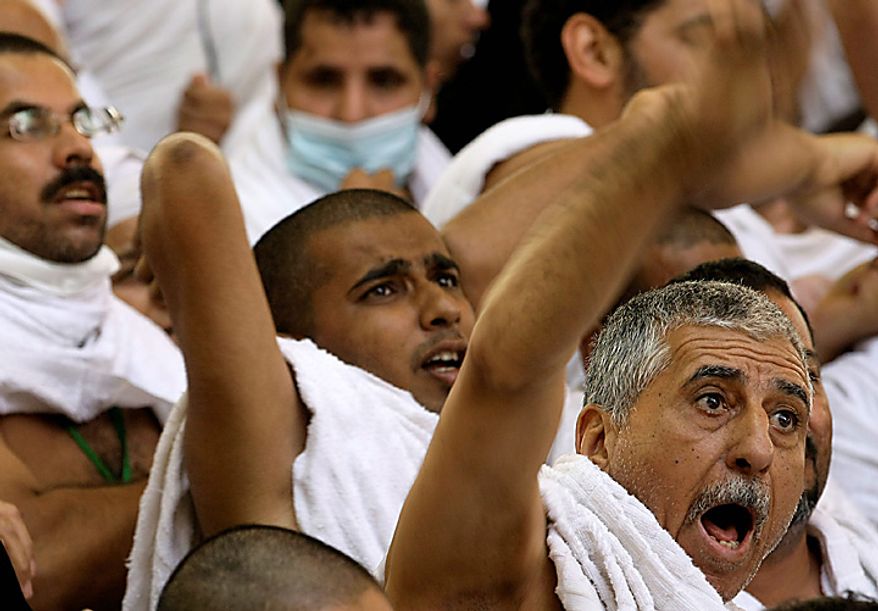 Muslim pilgrims cast stones at a pillar, symbolizing the stoning of Satan, in a ritual called "Jamarat," the last rite of the annual hajj, in Mina near the Saudi holy city of Mecca, Saudi Arabia, Tuesday, Nov. 16, 2010. The first day of stoning also marks the start of the Islamic holiday of Eid al-Adha, or feast of sacrifice. (AP Photo/Hassan Ammar)