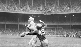 FILE - This Nov. 9, 1946, file photo shows Army fullback Felix &quot;Doc&quot; Blanchard (35), center left in front of the official, fumbling the ball, in air at center, during the first half against Notre Dame, at Yankee Stadium in New York. Teammate Glen Davis (41), left foreground, recovered the ball. Identifiable Notre Dame players are  Bill Fischer (72) and Jim Martin (38). Back then, Notre Dame and Army were at the top of the sport. Their rivalry was THE rivalry. College football was still a regional game, but the Fighting Irish and Black Knights had national followings. (AP Photo/File)