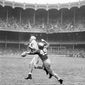 FILE - This Nov. 9, 1946, file photo shows Army fullback Felix &quot;Doc&quot; Blanchard (35), center left in front of the official, fumbling the ball, in air at center, during the first half against Notre Dame, at Yankee Stadium in New York. Teammate Glen Davis (41), left foreground, recovered the ball. Identifiable Notre Dame players are  Bill Fischer (72) and Jim Martin (38). Back then, Notre Dame and Army were at the top of the sport. Their rivalry was THE rivalry. College football was still a regional game, but the Fighting Irish and Black Knights had national followings. (AP Photo/File)