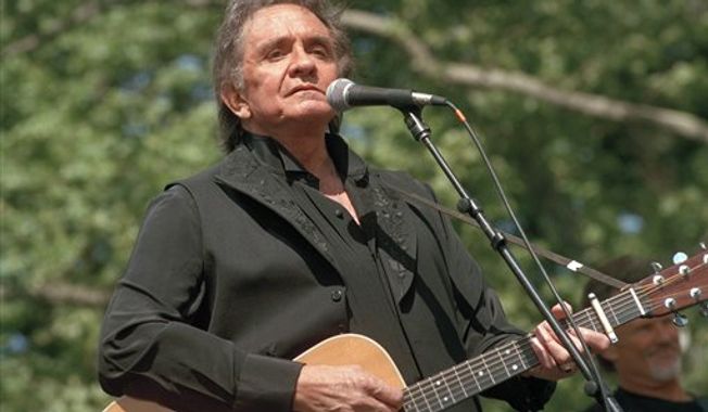 Johnny Cash performs at a benefit concert in Central Park in New York on May 23, 1993.   (Associated Press) 