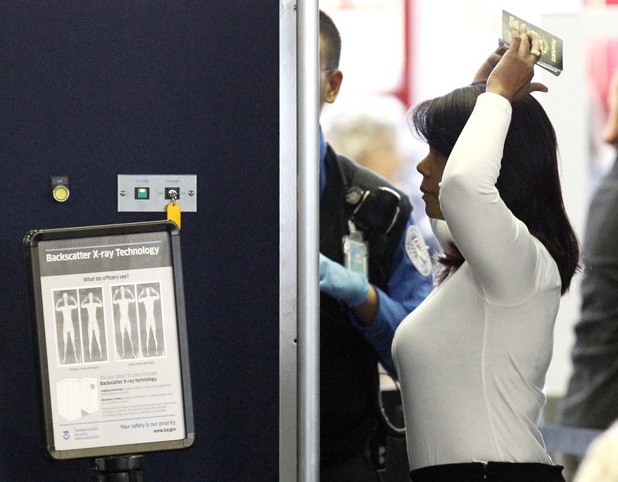 An airline passenger undergoes a full body scan at O'Hare International Airport Wednesday, Nov. 17, 2010 in Chicago. (AP Photo/Charles Rex Arbogast)