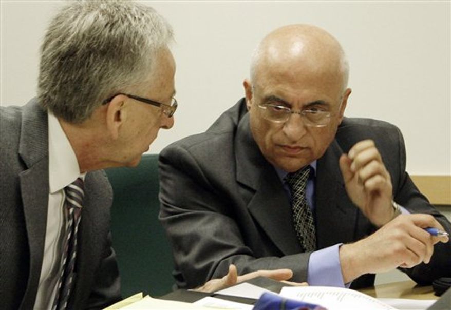 FILE- In this Monday Oct. 18, 2010 file photo showing fertility specialist Dr. Michael Kamrava, right, and his attorney Henry R. Fenton prepare for a hearing before the California Board of Medical Examiners on possible suspension or revocation of his medical license, in Los Angeles. He is accused of "grossly negligent'' treatment of `"Octomom'' Nadya Suleman and another patient. (AP Photo/Reed Saxon)