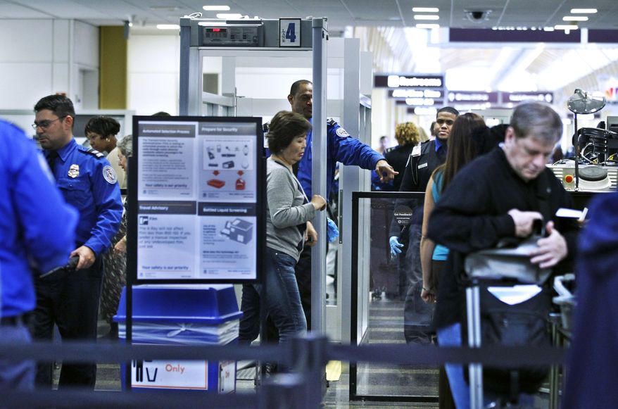 Transportation Security Administration officers (in blue uniforms) screen airline passengers at Ronald Reagan Washington National Airport on Monday, Nov. 15, 2010. (AP Photo/Manuel Balce Ceneta)