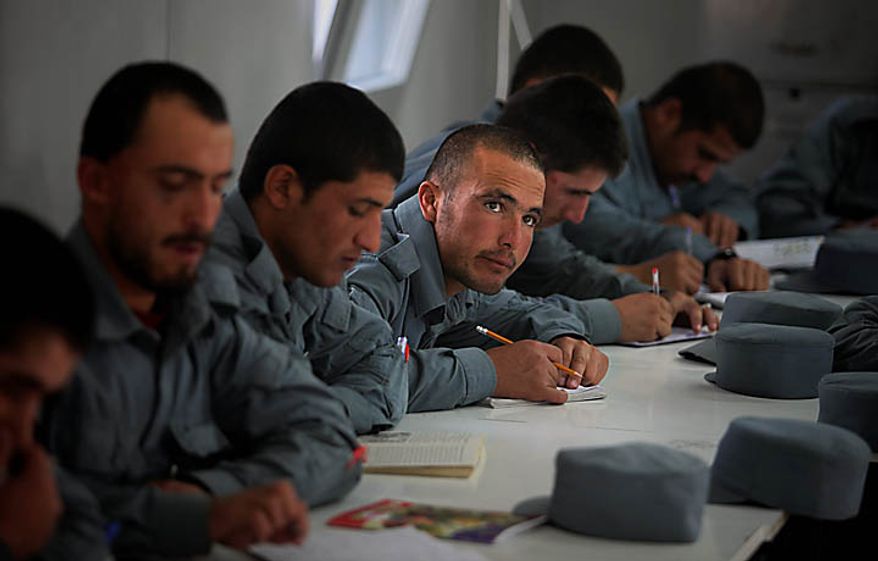 In this Nov. 7, 2010 photo, new Afghan police recruits attend a literary class at Central Training Center on the outskirts of Kabul, Afghanistan. According to the NATO training mission, only 11 percent of the enlisted personnel in the army and police can read and write, compared to 35 percent for non-commissioned officers and 93 for the officer corps. About 74 percent of the population is illiterate, but the percentage in the security forces tends to be higher since fewer educated Afghans are willing to sign up. (AP Photo/Altaf Qadri)