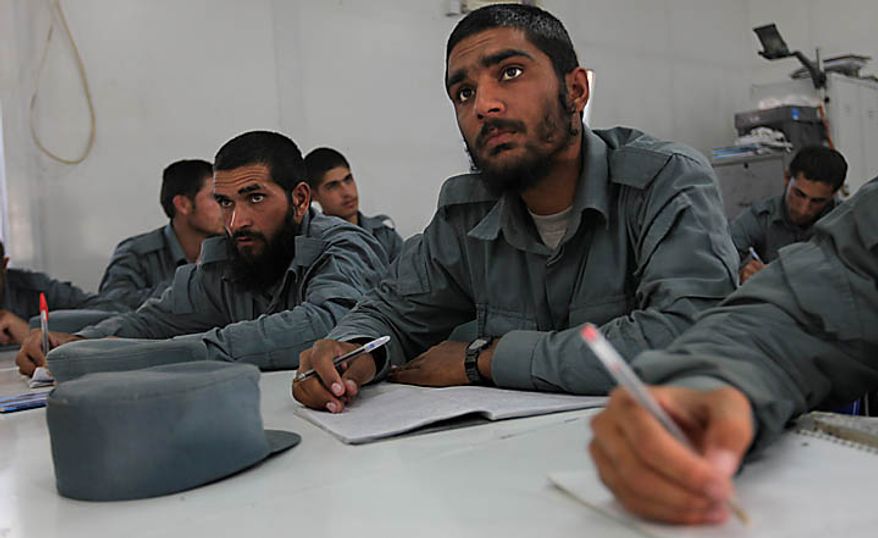 In this Nov. 7, 2010 photo, Khan Agha, new Afghan police recruit, center, attends a literary class at Central Training Center on the outskirts of Kabul, Afghanistan. According to the NATO training mission, only 11 percent of the enlisted personnel in the army and police can read and write, compared to 35 percent for non-commissioned officers and 93 for the officer corps. About 74 percent of the population is illiterate, but the percentage in the security forces tends to be higher since fewer educated Afghans are willing to sign up. (AP Photo/Altaf Qadri)
