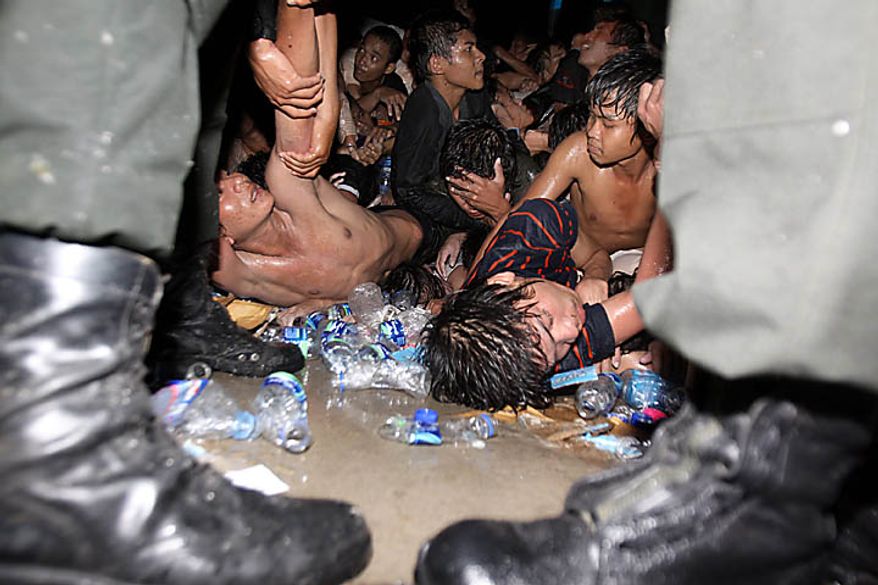 Injured visitors seek help after a stampede onto a bridge at an accident site during the last day of celebrations of the water festival in Phnom Penh, Cambodia, Monday, Nov. 22, 2010. Thousands of people celebrating a water festival on a small island in a Cambodian river stampeded Monday evening, killing many people, a hospital official said. Hundreds more were hurt as the crowd panicked and pushed over the bridge to the mainland. (AP Photo/Heng Sinith)