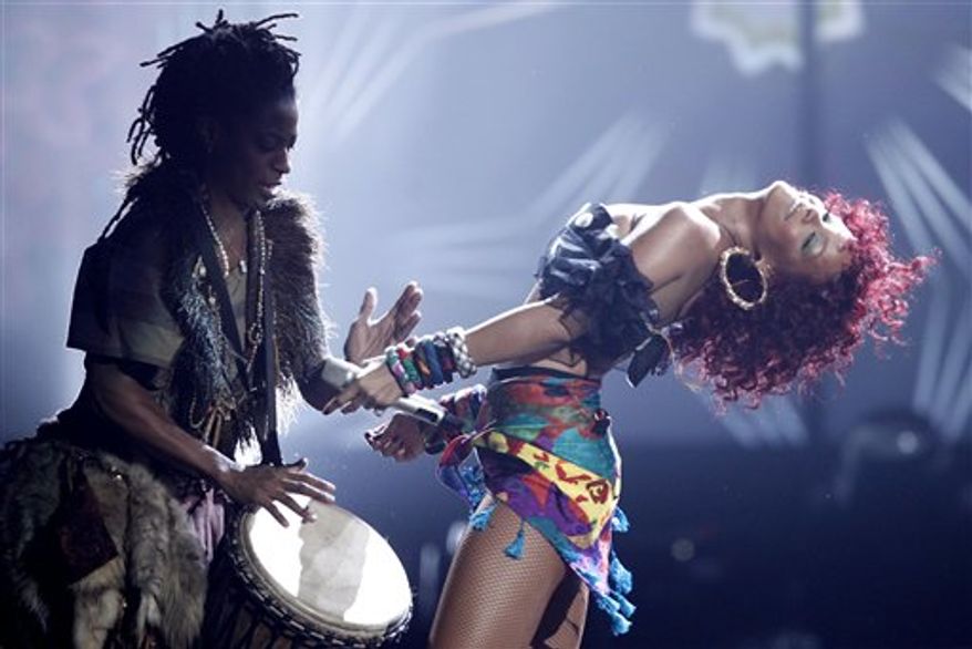 Rihanna, right, performs at the 38th Annual American Music Awards on Sunday, Nov. 21, 2010 in Los Angeles. (AP Photo/Matt Sayles)