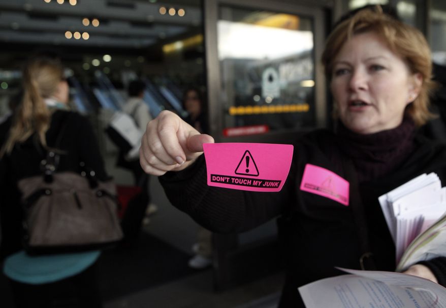 Activist Lori Lamb distributes stickers to travelers to protest against TSA's new security procedures at Los Angeles International Airport, Wednesday, Nov. 24, 2010. Holiday travelers dismayed by airport body scans planned protests at bustling airports Wednesday, while the head of the nation's transport security agency urged passengers to comply with searches to reduce the possibility of delays on one of the busiest travel days of the year. (AP Photo/Jae C. Hong)
