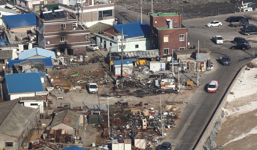 Destroyed houses are evident from the air Wednesday on Yeonpyeong Island, South Korea. Officials say they found the burned bodies of two islanders killed in the North Korean artillery attack, marking the first two civilian deaths in the crisis. (Associated Press/Yonhap)