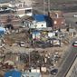 Destroyed houses are evident from the air Wednesday on Yeonpyeong Island, South Korea. Officials say they found the burned bodies of two islanders killed in the North Korean artillery attack, marking the first two civilian deaths in the crisis. (Associated Press/Yonhap)