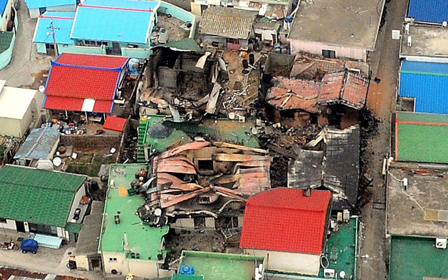 An aerial view shows destroyed houses on Yeonpyeong island, South Korea, Wednesday, Nov. 24, 2010, one day after North Korea's artillery attack on the island. Rescuers found the burned bodies Wednesday of two islanders killed in the attack _ the first civilian deaths from a skirmish that marked a dramatic escalation of tensions between the rival Koreas. (AP Photo/Yonhap, Kim Hyun-tae)