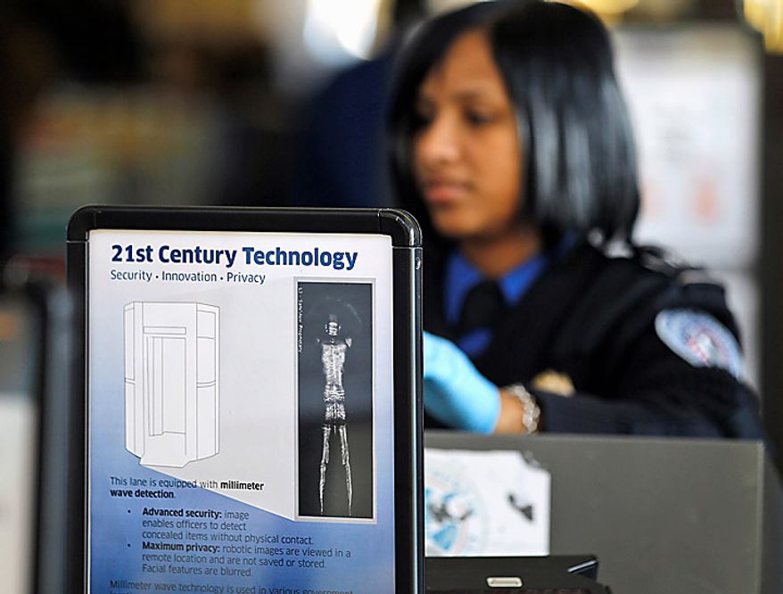 A sign helps explain the new technology to travelers at a TSA security checkpoint at Washington's Ronald Reagan Washington National Airport, Wednesday, Nov. 24, 2010, as the holiday travel season began. (AP Photo/Alex Brandon)