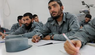 Khan Agha is taking a literacy class as part of the NATO training mission. Only 11 percent of the enlisted personnel in the army and police can read and write, compared with 35 percent for noncommissioned officers and 93 for the officer corps. (Associated Press)