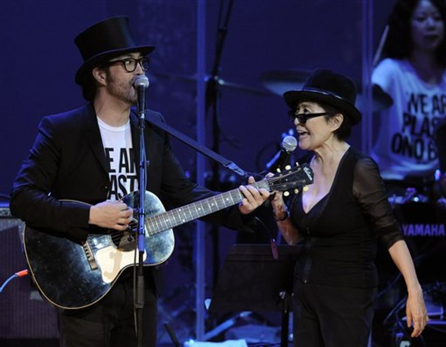 FILE - In this Oct. 1, 2010 file photo, Yoko Ono, right, performs alongside her son Sean Lennon during the "Yoko Ono: We Are Plastic Ono Band" concert at the Orpheum Theater in Los Angeles. Ono and her son, Sean Lennon, are joining a national oral history project that urges people to take time the day after Thanksgiving for a National Day of Listening with their friends and loved ones. (AP Photo/Chris Pizzello, File)