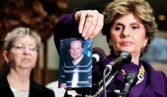Associated Press
At a news conference Tuesday in Rockville, Md., Gloria Allred, attorney for the family of homicide victim Brian Betts, displays a photo of the one-time principal of a D.C. middle School who was killed in his Silver Spring, Md., home.