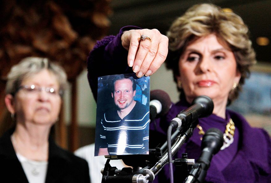Associated Press
At a news conference Tuesday in Rockville, Md., Gloria Allred, attorney for the family of homicide victim Brian Betts, displays a photo of the one-time principal of a D.C. middle School who was killed in his Silver Spring, Md., home.