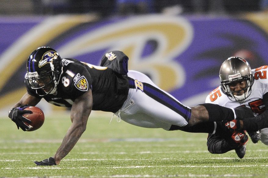 Baltimore Ravens wide receiver Anquan Boldin (81) is tackled by Tampa Bay Buccaneers cornerback Aqib Talib (25) after a pass reception during the second half of an NFL football game, Sunday, Nov. 28, 2010, in Baltimore. (AP Photo/Nick Wass)