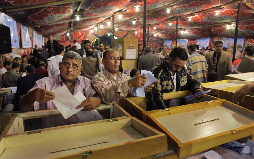Electoral workers count ballots at a counting center after polls closed in the Abdeen neighborhood of Cairo on Sunday, Nov. 28, 2010. Egypt's parliamentary election was marred by scattered violence, reports of vote buying and the ejection of many independent monitors from polling stations amid what opponents say is a government campaign to clamp down at a time of political uncertainty. (AP Photo/Ben Curtis)