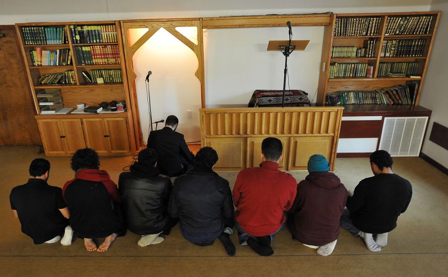 Imam Yosef Wanly (upper center) leads a prayer service at the Salman Al-Farisi Islamic Center in Corvallis, Ore., on Saturday, Nov. 27, 2010. Mohamed Osman Mohamud, 19, a former Oregon State University student who allegedly planned a bombing in Portland, Ore., during Friday's Christmas-tree-lighting ceremony, attended the center, which was struck by fire on Sunday. (AP Photo/Steve Dykes)