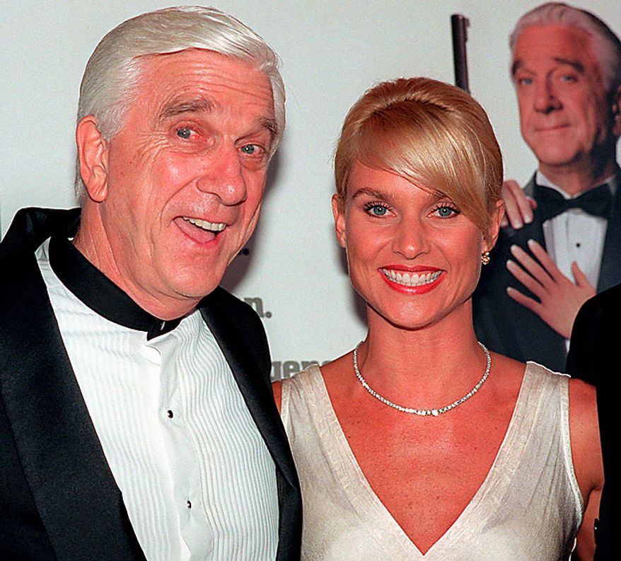 In this file photo taken May 16, 1996, actors Leslie Nielsen, left, and Nicollette Sheridan arrive at the El Capitan Theatre in Los Angeles for the premiere of "Spy Hard." The Canadian-born Nielsen, who went from drama to inspired bumbling as a hapless doctor in "Airplane!" and the accident-prone detective Frank Drebin in "The Naked Gun" comedies, has died. He was 84. His agent John S. Kelly said Nielsen died Sunday, Nov. 28, 2010, at a hospital near his home in Florida where he was being treated for pneumonia. (AP Photo/Michael Caulfield, File)
