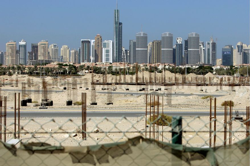 ASSOCIATED PRESS PHOTOGRAPHS
Dubai Marina towers form the backdrop to a construction site that has been stalled since a financial crisis hit Dubai in 2009.