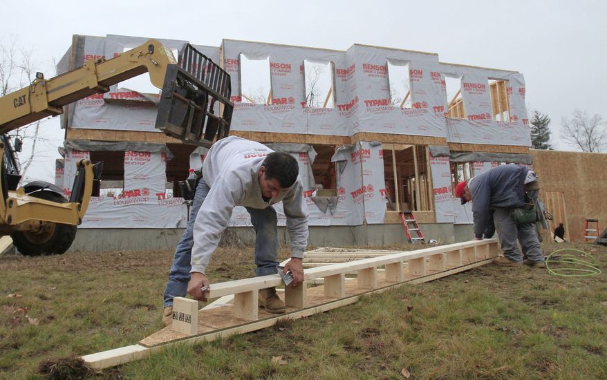 In this Nov. 16, 2010, photo, builders nail together a roof panel for a second-story home under construction in Derry, N.H. Home prices are falling faster in the nation's largest cities, and a record number of foreclosures are expected to push prices down further through next year. (AP Photo/Charles Krupa)