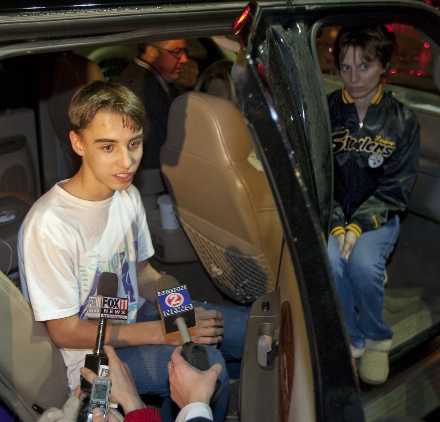 Austin Biehl talks to reporters on Monday night, Nov. 29, 2010 in Marinette, Wis., about being taken hostage at Marinette High School by another student earlier in the day, as his mother Carla looks on at right. (AP Photo/Mike Roemer)
