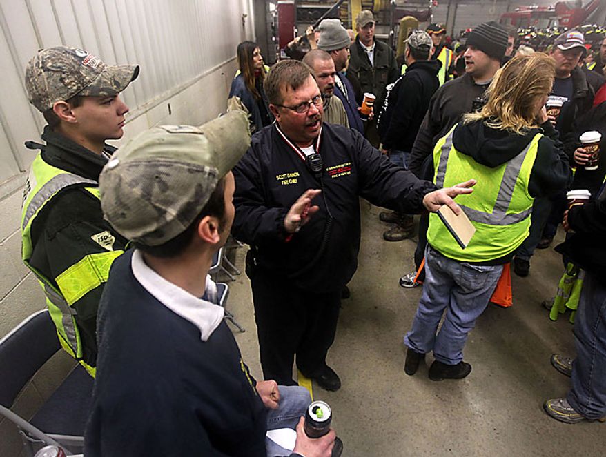 Chief Scott Damon, of Cambridge Township Fire Department organizes a search party at the Morenci fire department in Morency, Mich, for 9-year-old Andrew, 7-year-old Alexander and 5-year-old Tanner Skelton Tuesday, Nov. 30, 2010. Authorities "do not anticipate a positive outcome" in the search for three Michigan brothers who have been missing since their father's attempted suicide, a police chief said Tuesday. (AP Photo/Detroit Free Press, Andre J. Jackson)