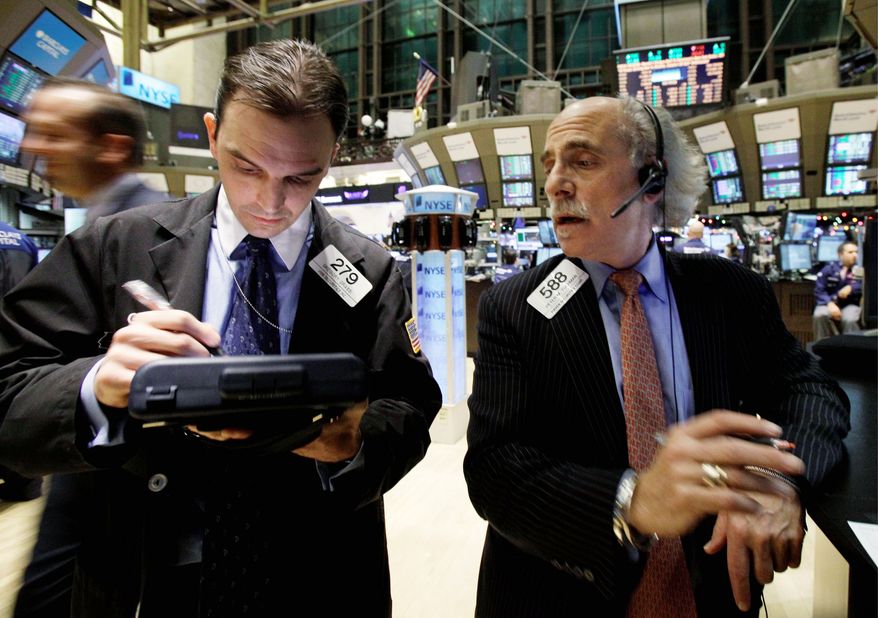 ASSOCIATED PRESS
Traders Gregory Grassi (left) and Peter Tuchman confer on the floor of the New York Stock Exchange on Wednesday. The Dow Jones industrial average rose nearly 250 points, its biggest gain since Sept. 1.