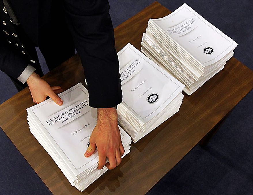 The Debt Commission report is brought out before their meeting on Capitol Hill in Washington, Wednesday, Dec. 1, 2010. (AP Photo/Alex Brandon)