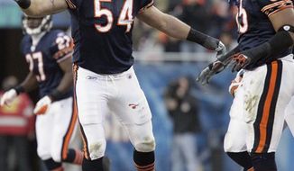 FILE - In this Nov. 28, 2010 file photo, Chicago Bears linebacker Brian Urlacher (54) reacts to a play with teammate Lance Briggs (55) during an NFL football game against the Philadelphia Eagles in Chicago. Between the wrist injury last year and the neck and back problems before that, there were all sorts of questions about Urlacher. Teammates, however, insist they had no doubts. Now, Urlacher is up to his old Pro Bowl tricks again for the Bears. (AP Photo/Nam Y. Huh, File)