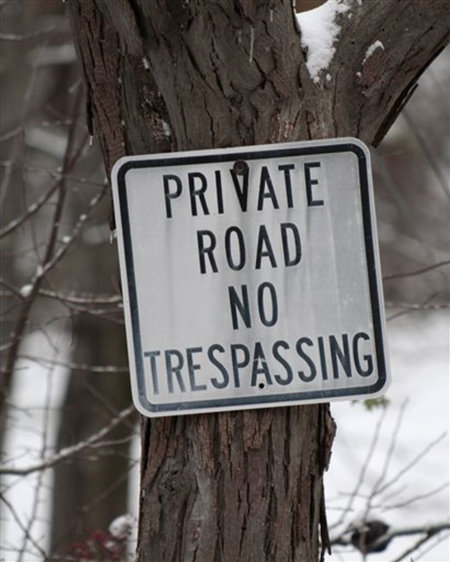 A sign at right marks a private road on Oakridge Lane near the residence of Aaron and Christine Boring, in Franklin Park, Pa. on Thursday, Dec. 2, 2010. Google Inc. has acknowledged that it trespassed when it took a photo of their Pittsburgh-area house for its Street View service, but will pay only $1 in damages to the couple who sued. U.S. District Magistrate Judge Cathy Bissoon on Thursday, Dec. 2, 2010, signed off on a consent judgment with the mutually agreed-upon verdict. (AP Photo/Keith Srakocic)