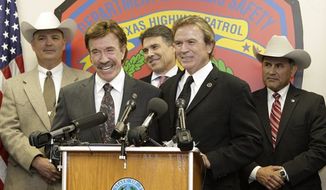 Actor Chuck Norris wears a honorary Texas Rangers law enforcement pin during a ceremony Thursday, Dec. 2, 2010, in Garland, Texas. Martial-arts expert Norris became a real-life honorary Texas Ranger after having played a Ranger for years on television. (AP Photo/Tony Gutierrez)