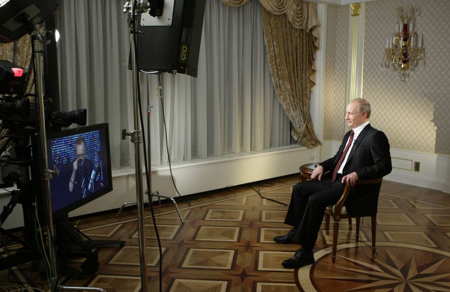 Then-Russian prime minister, now president, Vladimir Putin records a CNN interview with Larry King in Moscow in 2010. King will host a new talk show, "Politics With Larry King" for Russian TV network RT. (AP Photo/RIA Novosti, Alexei Nikolsky, Pool)