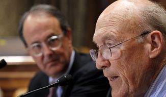 ** FILE ** In this Nov. 10, 2010, file photo, Erskine Bowles, left, watches former Wyoming Sen. Alan Simpson, co-chairman of President Barack Obama&#x27;s bipartisan deficit commission, speak at a news conference on Capitol Hill in Washington. (AP Photo/Alex Brandon, File)