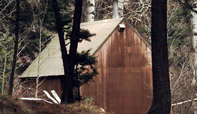 ** FILE ** The cabin of Theodore Kaczynski, dubbed the "Unabomber," is shown in the woods of Lincoln, Mont., in 1996. The 1.4-acre parcel of land once owned by Kaczynski is on the market for $69,500. The cabin now is on exhibit at the Newseum in Washington. (AP Photo/Elaine Thompson, File)