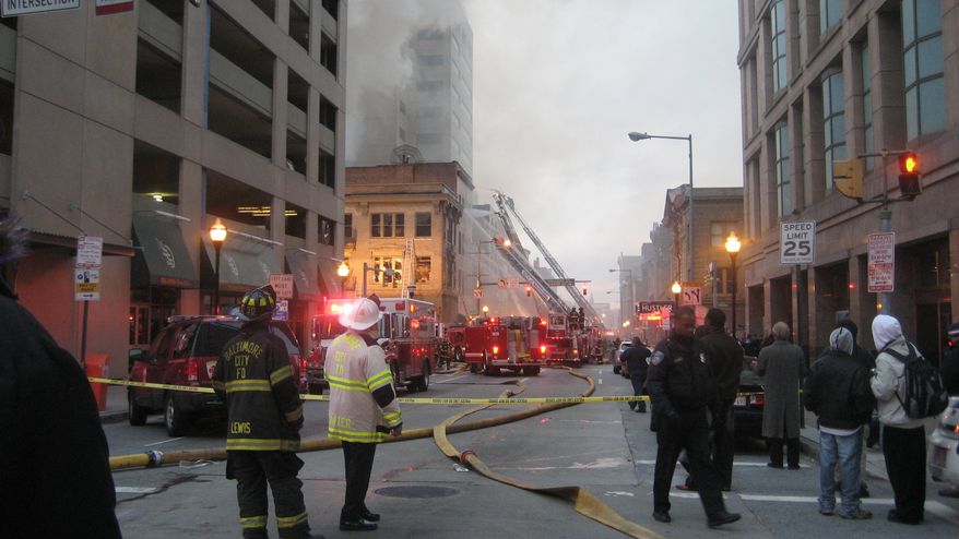 Firefighters work the scene of a multi-alarm blaze in a row of strip clubs Monday, Dec. 6, 2010, in Baltimore. Smoke spread over much of downtown Monday afternoon in the 400 block of Baltimore Street, an adult entertainment district known as The Block. Two office buildings were evacuated. (AP Photo/Alex Dominguez)