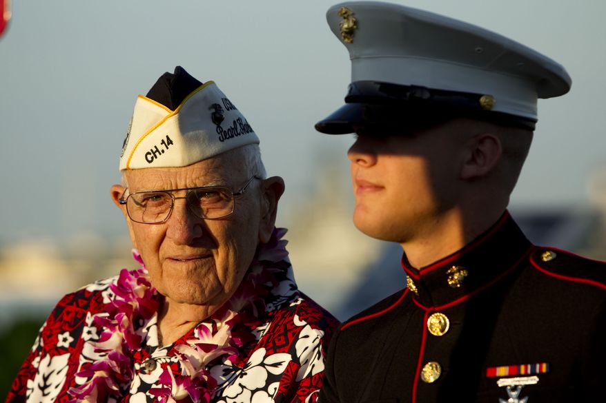Pearl Harbor survivor John Hughes (left) and Lance Cpl. Zackary Morphew attend the 69th anniversary ceremony marking the attack on Pearl Harbor on Tuesday, Dec. 7, 2010, in Pearl Harbor, Hawaii. (AP Photo/Marco Garcia)