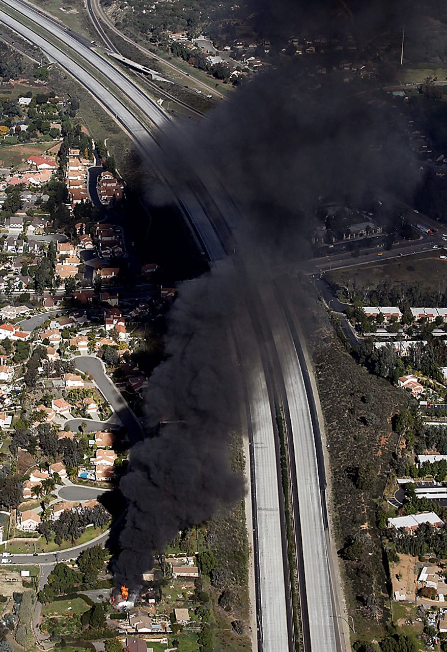 A suburban house erupts in flames on Thursday, Dec. 9, 2010 during the controlled burn of a home in Escondido, Calif., that was so packed with homemade explosives that authorities claim they had no choice but to burn it to the ground. The house was rented by an out-of-work software consultant who allegedly assembled an astonishing quantity of bomb-making materials that included chemicals used by Middle Eastern suicide bombers.(AP Photo/Chris Carlson)