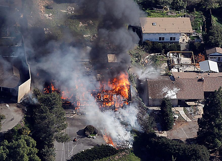A suburban home erupts in flames on Thursday, Dec. 9, 2010 during the controlled burn of a home in Escondido, Calif., that was so packed with homemade explosives that authorities claim they had no choice but to burn it to the ground. The house was rented by an out-of-work software consultant who allegedly assembled an astonishing quantity of bomb-making materials that included chemicals used by Middle Eastern suicide bombers.(AP Photo/Chris Carlson)