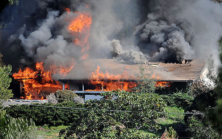 A house erupts in flames on Thursday, Dec. 9, 2010 during the controlled burn of a home in Escondido, Calif., that was so packed with homemade explosives that authorities claim they had no choice but to burn it to the ground. The house was rented by an out-of-work software consultant who allegedly assembled an astonishing quantity of bomb-making materials that included chemicals used by Middle Eastern suicide bombers. (AP Photo/Denis Poroy)