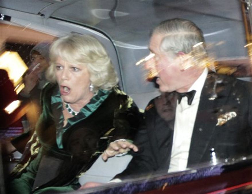 Britain's Prince Charles and Camilla, Duchess of Cornwall, react as their car is attacked by angry protesters in London, Thursday, Dec. 9, 2010. An Associated Press photographer saw demonstrators kick the car in Regent Street, in the heart of London's shopping district. The car then sped off. Charles' office, Clarence House, confirmed that "their royal highnesses' car was attacked by protesters on the way to their engagement at the London Palladium this evening, but their royal highnesses are unharmed." (AP Photo/Matt Dunham)