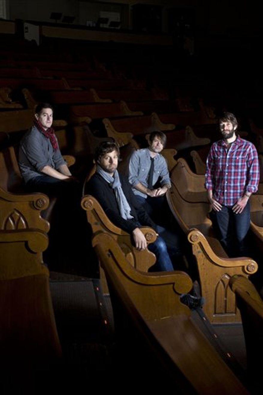 This Dec. 8, 2010 picture shows members of the band Jars of Clay, Dan Haseltine, left, Matt Odmark, Charlie Lowell, and Stephen Mason, at the Ryman Auditorium in Nashville, Tenn. The group recently met their goal of providing clean water to 1,000 African communities through the organization they founded, Blood:Water Mission, and its 1,000 Wells Project. They're celebrating the milestone with a benefit concert at Nashville's Ryman Auditorium on May 10. (AP Photo/Josh Anderson)