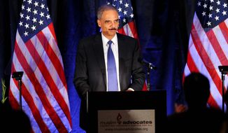 Attorney General Eric Holder speaks at the Muslim Advocates annual dinner on Friday, Dec. 10, 2010, in Millbrae, Calif. Holder used the speech before the Muslim advocacy group near San Francisco to reiterate his resolve to prosecute hate crimes. (AP Photo/Noah Berger)