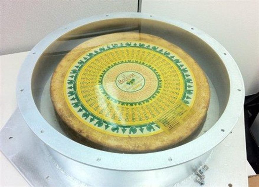 This image provided Thursday Dec. 9, 2010 by SpaceX shows a wheel of cheese that was bolted onto the floor of its Dragon spacecraft capsule for Wednesday's test flight from Florida. The capsule containing the secret payload, the cheese, parachuted to a Pacific Ocean splashdown and is now on a barge headed to California. (AP Photo/SpaceX, Chris Thompson)