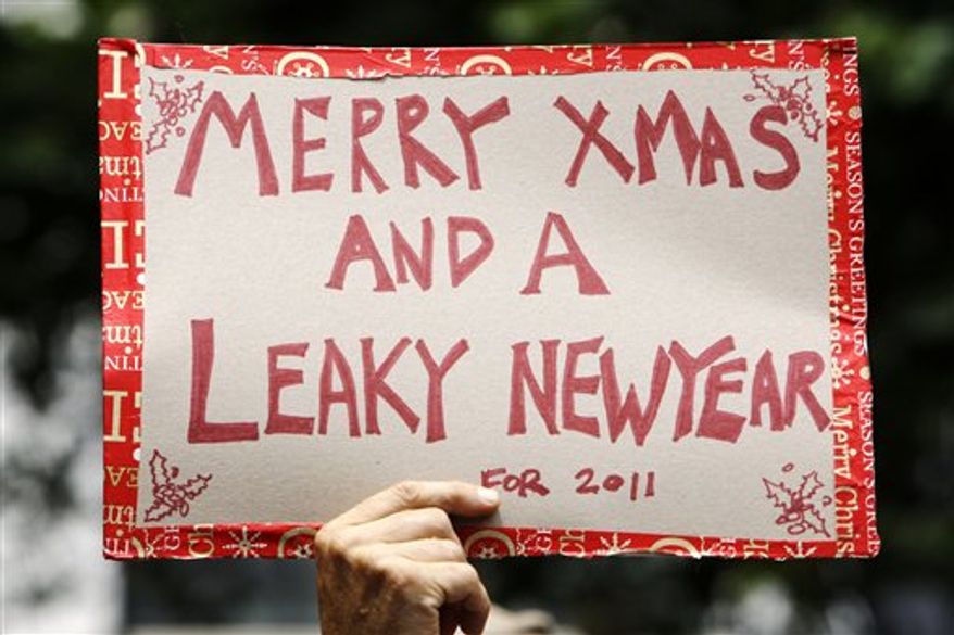 A man carries a placard as protesters gather in support of WikiLeaks and its founder Julian Assange in Sydney, Friday, Dec. 10, 2010. WikiLeaks' extensive releases of secret U.S. diplomatic cables have embarrassed U.S. allies, angered rivals, and reopened old wounds across the world. U.S. officials in Washington say other countries have curtailed their dealings with the U.S. government because of WikiLeaks' actions. (AP Photo/Rick Rycroft)