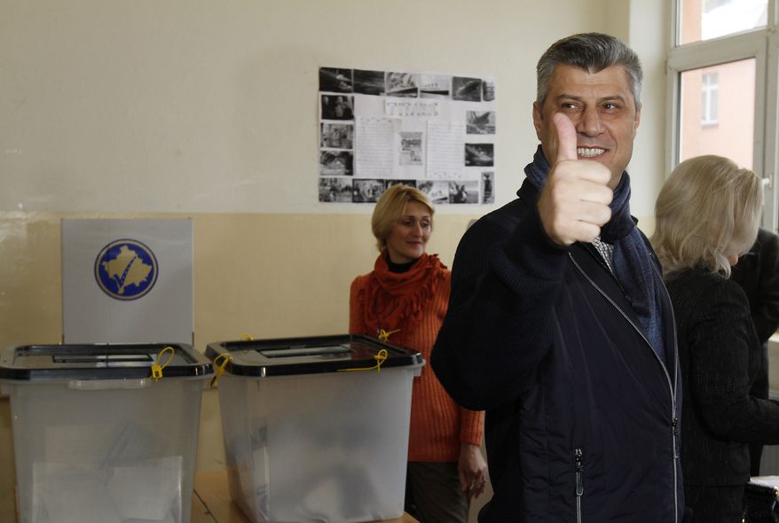 Hashim Thaci, leader of the Democratic Party of Kosovo, gives a thumbs up as he arrives to cast his ballot in general elections in Kosovo's capital, Pristina, on Sunday, Dec. 12, 2010. Kosovars were voting in the first general poll since the country's declaration of independence from Serbia in 2008, a critical election already marred by ethnic tension that many feared would split the world's newest country. (AP Photo/Visar Kryeziu)