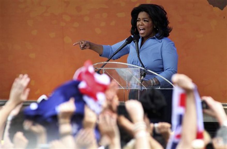 In this photo released by Harpo Productions Inc., talk show host Oprah Winfrey, center, chats with actor Russell Crowe, and his wife Danielle Spencer, right, while sailing on Sydney Harbour, Monday, Dec. 13, 2010. Winfrey is taping two episodes of her show outside Sydney's Opera House, Tuesday. (AP Photo/Harpo Productions Inc., George Burns) EDITORIAL USE ONLY